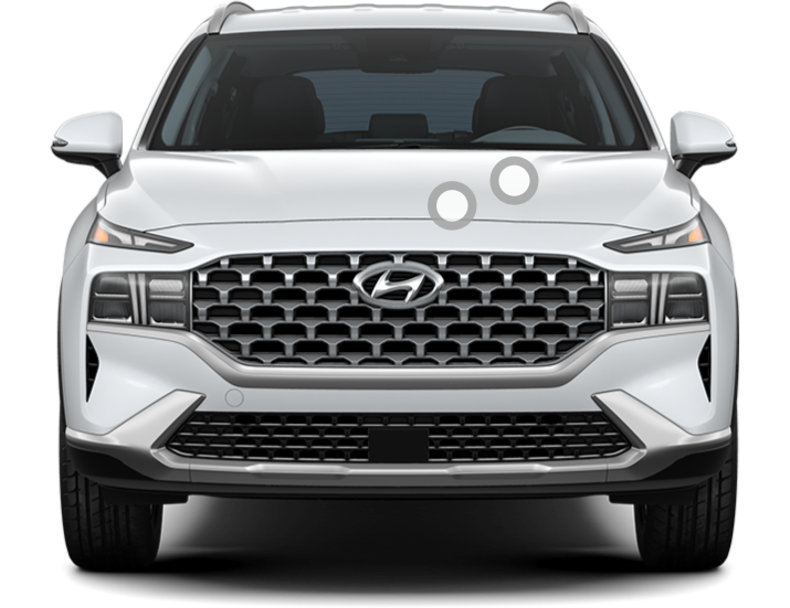 Front view of a white Hyundai Santa Fe, showcasing its grille, headlights, and bold SUV styling.