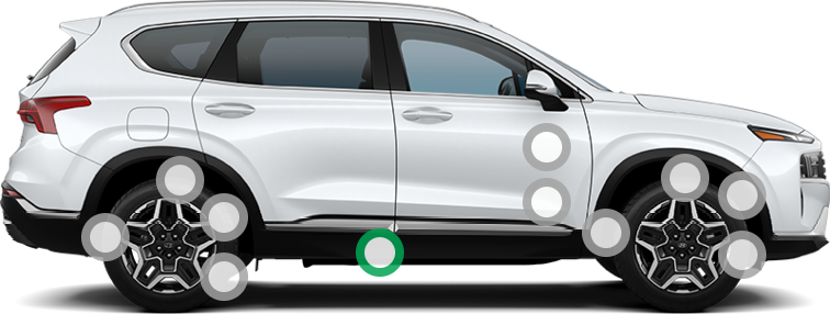 Passenger side profile of a white Hyundai Santa Fe.